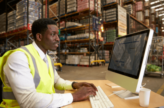 Person in a warehouse using inventory management solutions